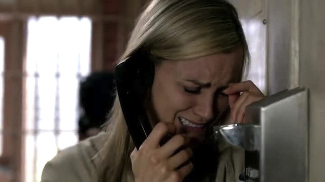 Stock Photo #3564: Woman Cries While on the Phone, Leans, Hand to Forehead. 