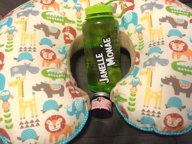 Breastfeeding must-haves: my Boppy pillow, a lot of H2O, and nipple butter.