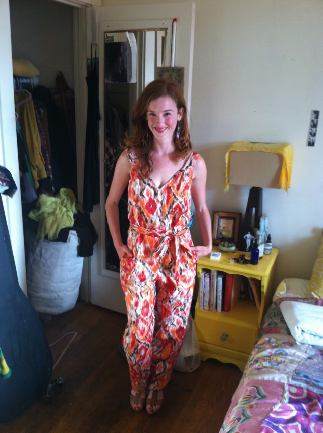 Leanne stands smiling in an amazing floral printed jumpsuit.