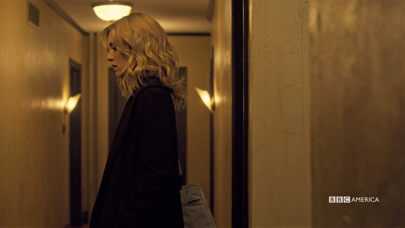 Delphine stands in the hallway looking great and a little shady but it's okay I love her anyway