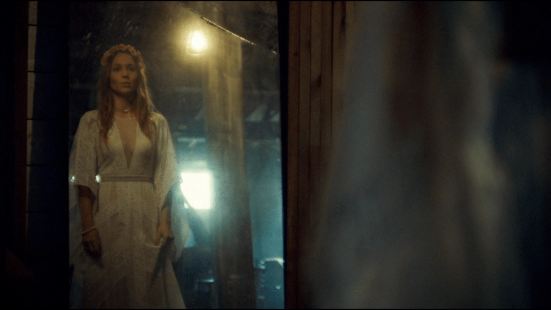 Waverly looks in the mirror wearing her mother's wedding dress