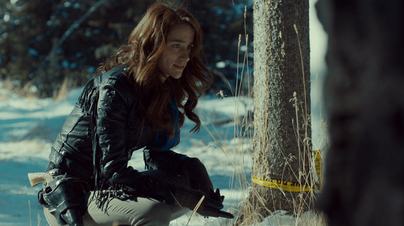 Wynonna crouches down to inspect evidence