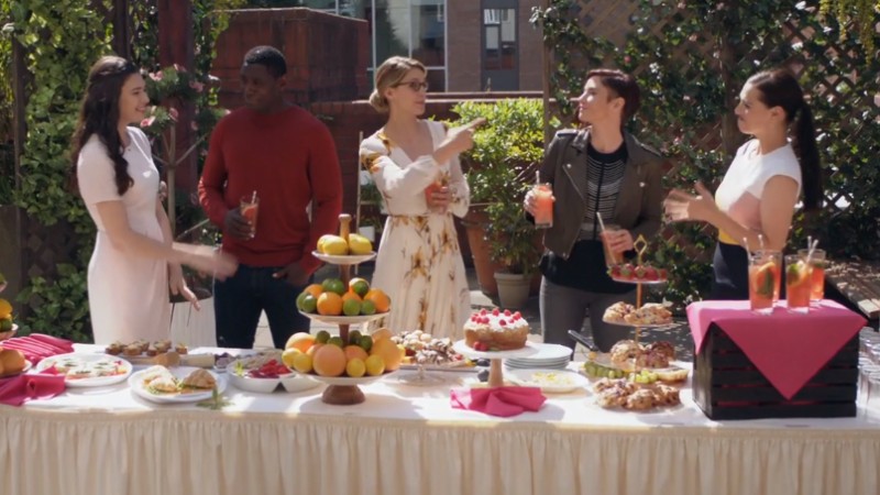 Team Super laughs while on a sunshiney rooftop garden 