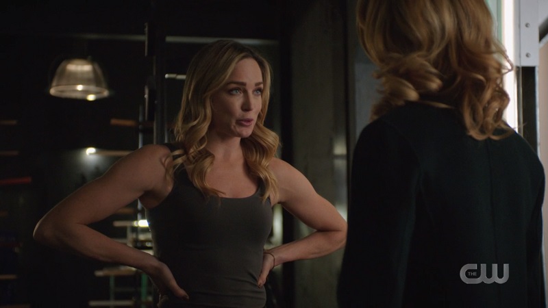 Sara has her hands on her hips and her ARMS are very muscley 