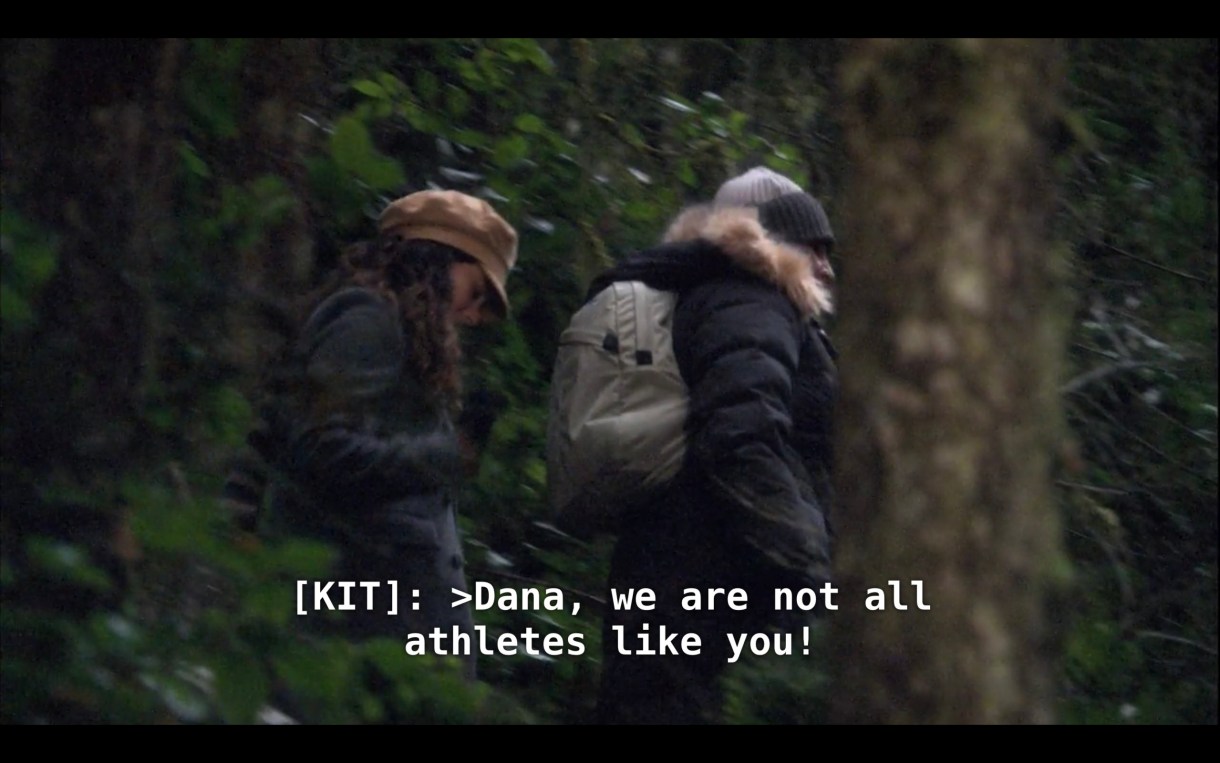 Kit and Jenny are hiking next to each other through a forest. Kit says, "Dana, we are not all athletes like you!"