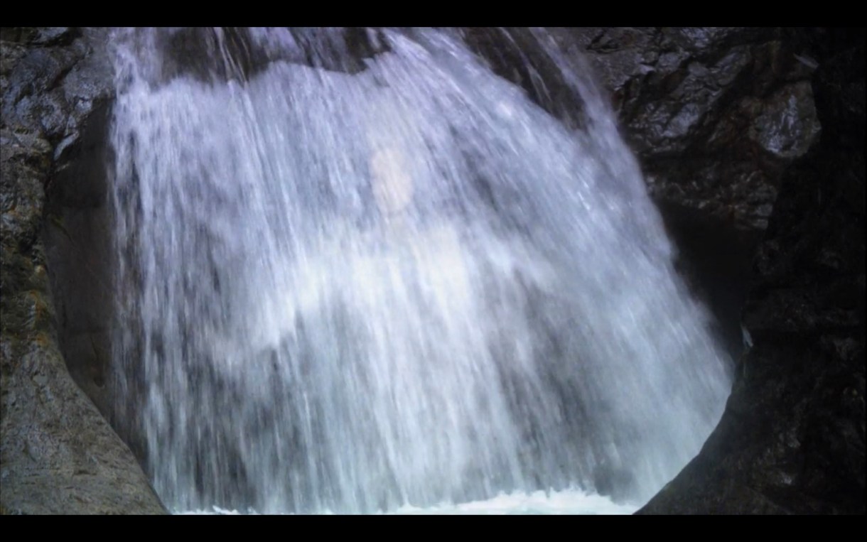 A serene waterfall. Ever so slightly Dana's body can be seen glimmering in the falling water.