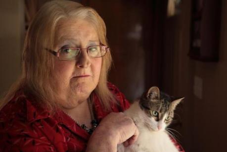 Aimee Stephens strokes her cat with a content smile.