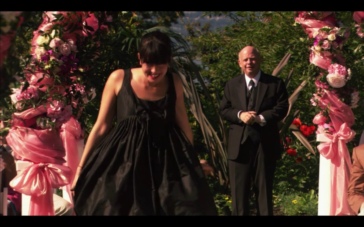 Jenny arriving at the wedding, wearing her garbage bag dress and running down the aisle.