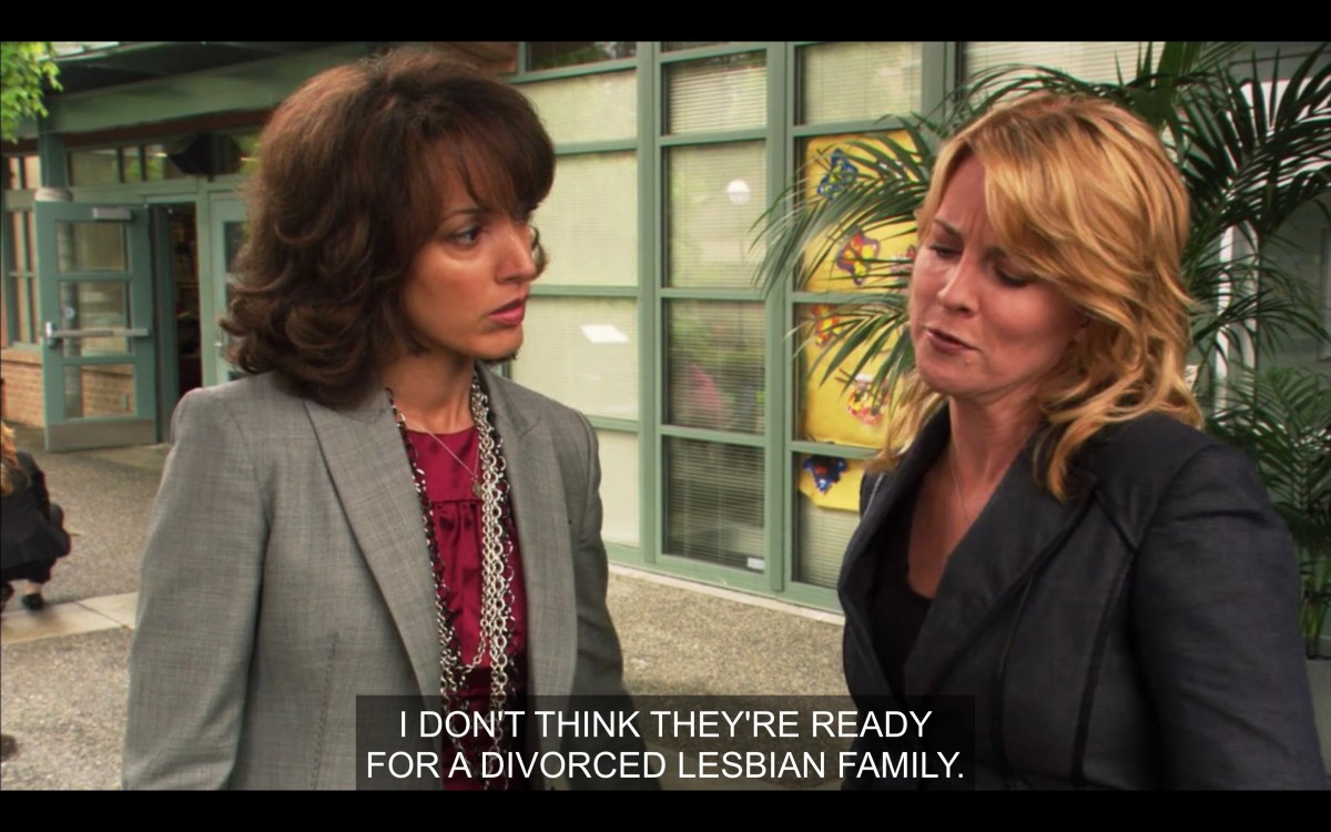 Bette, in a magenta shirt and a grey blazer, is looking at Tina, they are standing outside a preschool and Tina is saying that they're not ready for a divorced lesbian family.