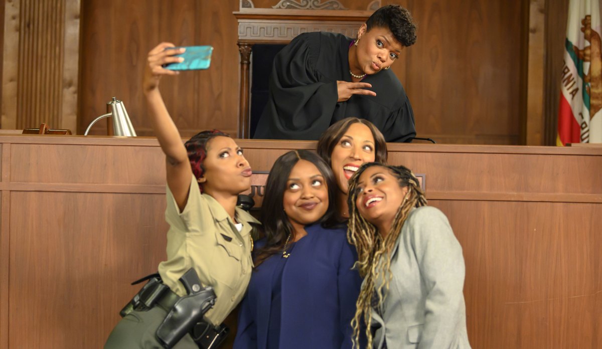 Still from an episode of "Black Lady Sketch Show," featuring four cast members taking a selfie in front of a judge