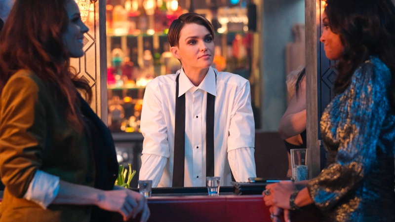Kate stands between Sophie and Nocturna in a tux shirt with the tie undone