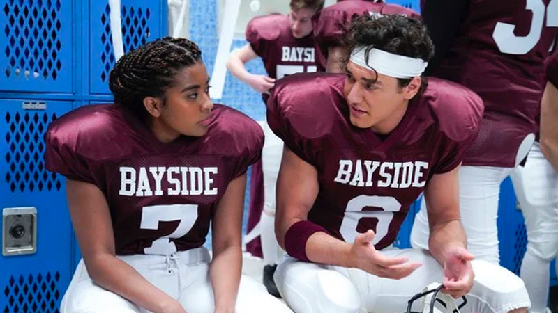 Aisha (Alycia Pascual-Pena) in her football jersey in the Bayside High locker room. 