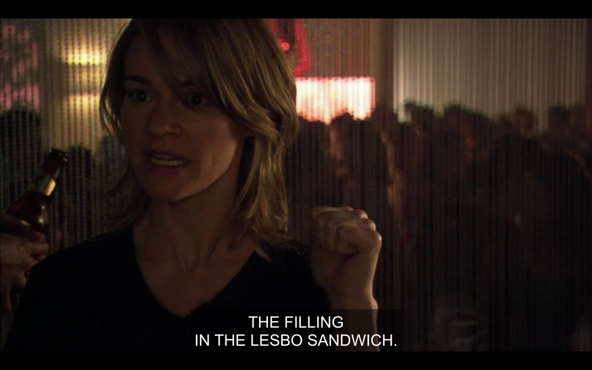 Alice gestures towards Dylan saying "the filling in the lesbo sandwich"