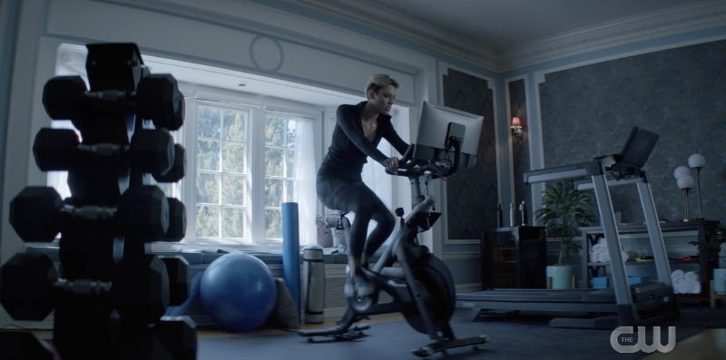 New Kate is riding on a exercise bike with a screen attached.