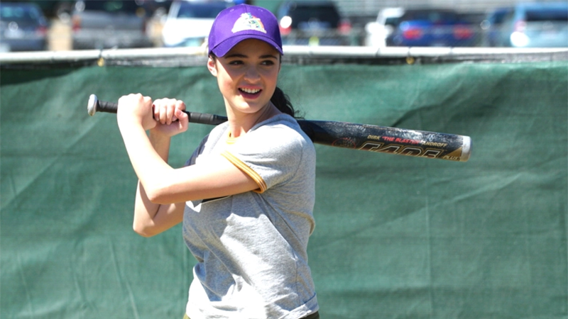 Nicole holds a softball bat