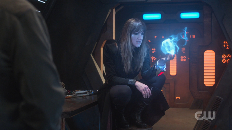 Supergirl recap 615: Nyxly sits gayly on a chair and looks at her magic ball of energy