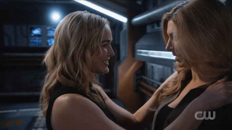 Sara grabs Ava by the shoulders, smiling flirtatiously