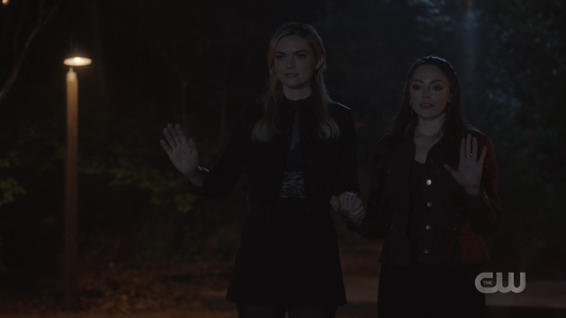 Legacies: Lizzie and Hope aka Hizzie hold hands on the dock in the dark