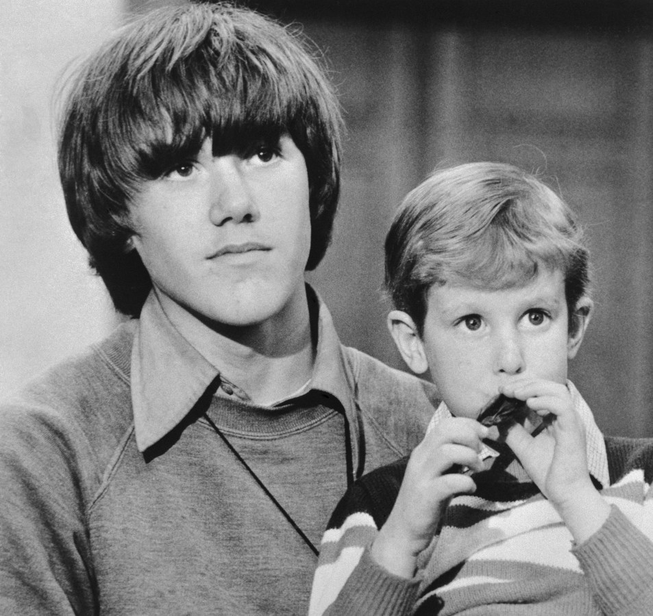 Timmy White, 5, who disappeared on Valentine's Day, sits on the lap of Steven Stayner, 14 and tries to blow a balloon up during press conference. Stayner disappeared seven years ago and told the press that he took Timmy from their captor's home because "I didn't like what was happening." Police arrested Kenneth E. Parnell on kidnapping charges.