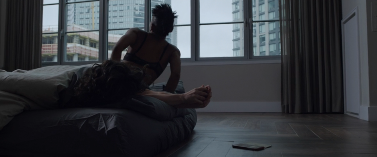 Carmen from The Good Fight in bed with someone with dark curly hair