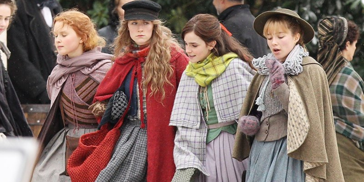 The cast of Little Women walking arm in arm