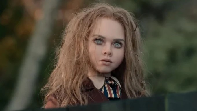 The doll M3GAN has mussed hair and a vacant look in her eyes