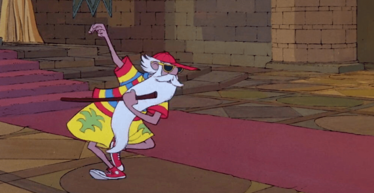 a screen shot of merlin in disney's the sword and the stone dancing around in his vacation outfit which is a red baseball cap, rainbow tee shirt, florida shorts, and converse sneakers. he is giddily dancing