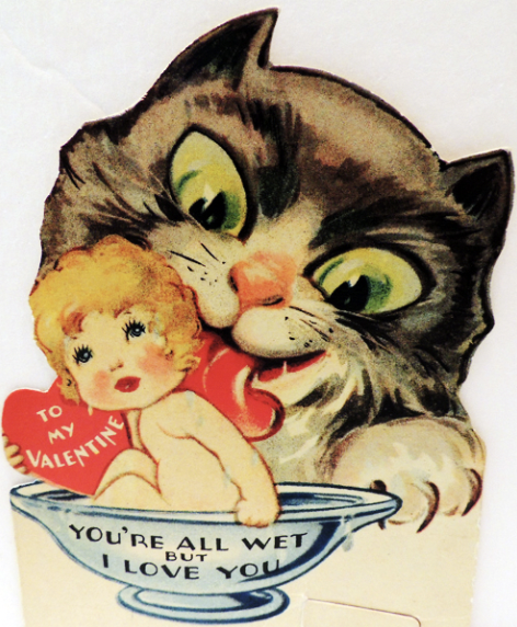 in this creepy image a giant cat licks a naked baby figure in a saucer. a heart with text on it reads "to me valentine" the saucer reads "you're all wet but i love you" and the baby looks stressed and the cat devious with large green eyes and a huge pink tongue.