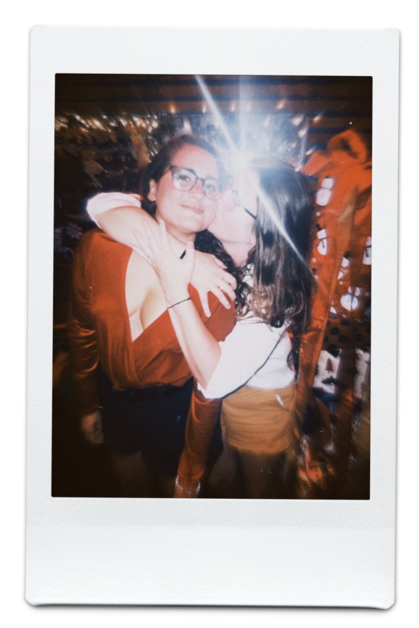 Kristen holds Kayla who is in a red jumpsuit