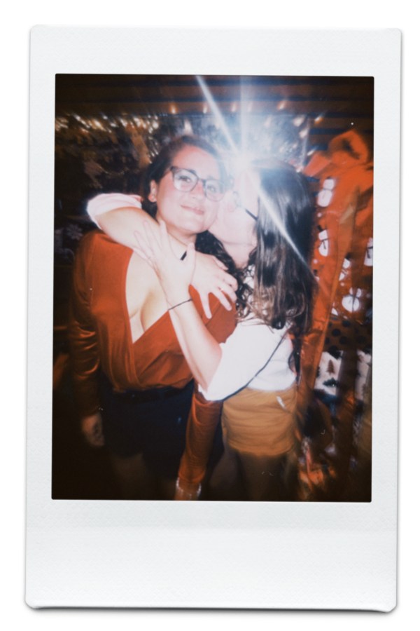 Kristen holds Kayla who is in a red jumpsuit