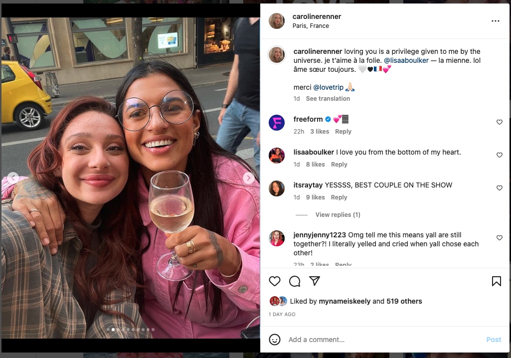 Caroline and Lisa embracing, Lisa holding a glass of wine