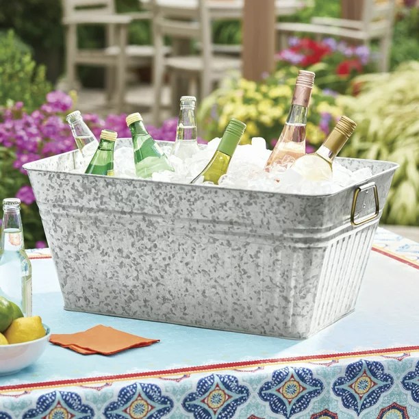 a large metal ice tub full of drinks and ice