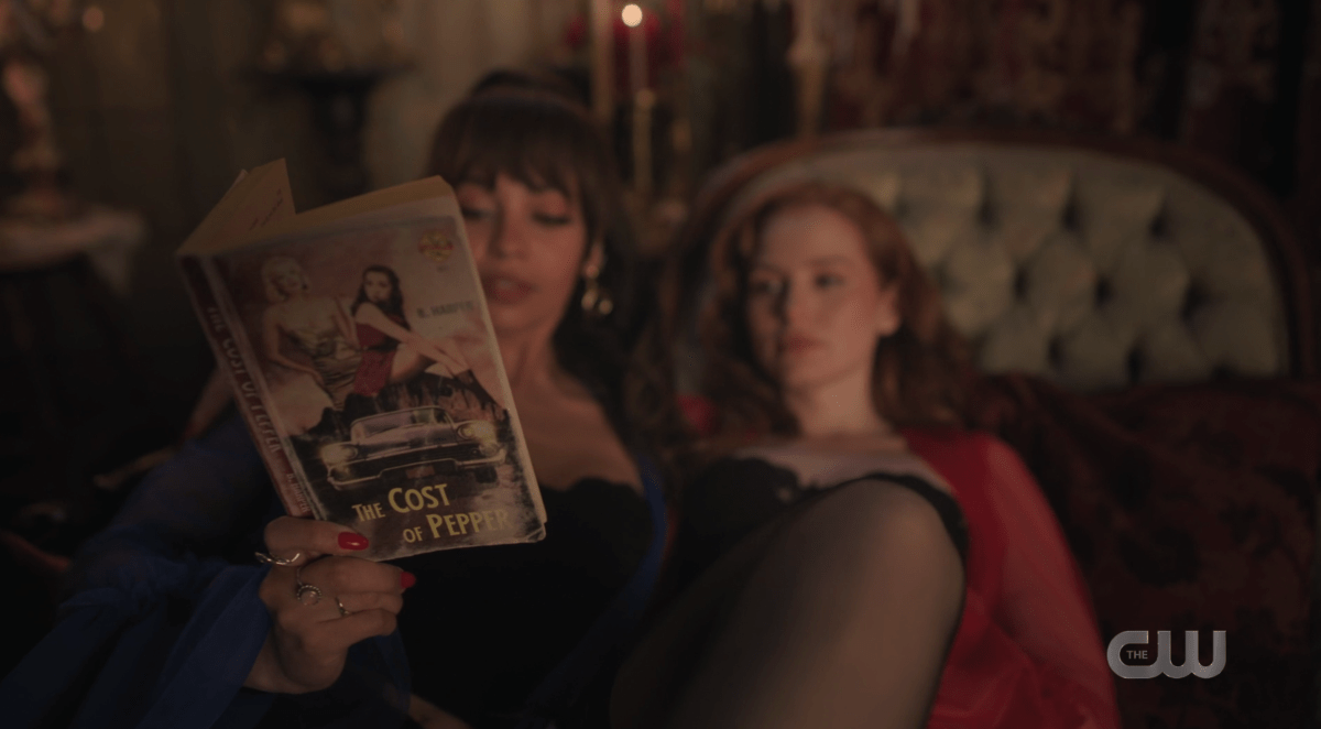 Toni holding a copy of THE COST OF PEPPER during her photoshoot with Cheryl