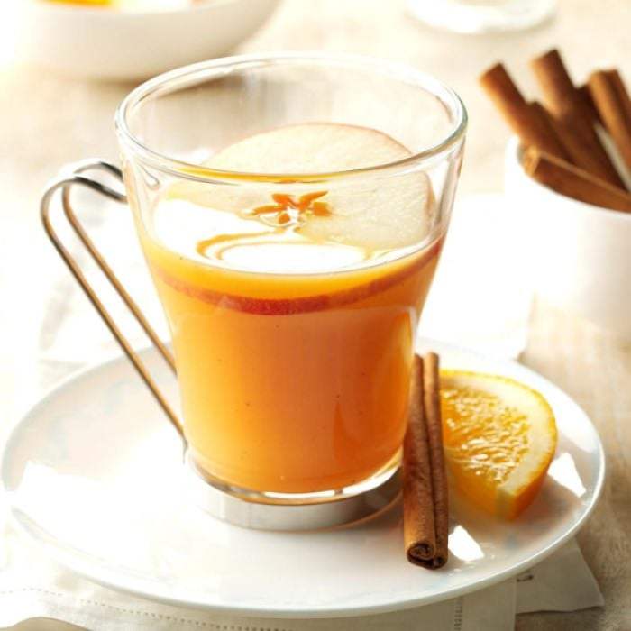 a glass of spiced orange cider