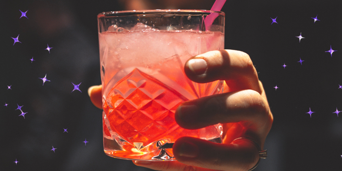 a bartender handing a cocktail to you