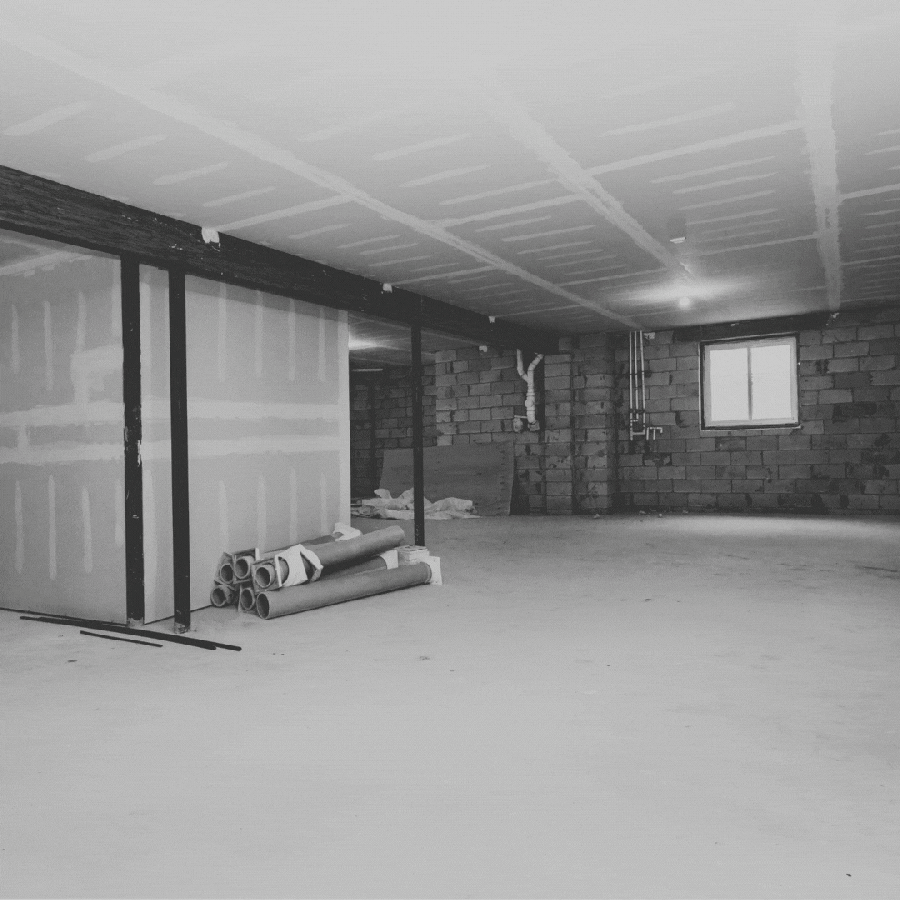 a GIF showing a black and white photo of a basement. On top of it appears a pair of women in high vis and construction protective gear. then, behind them appears a bulldozer, all in purple, pink and orange. looks like Pisces' bad new year's resolution for their zodiac sign is to dig a tunnel in their basement.