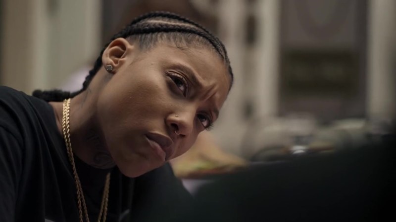Chastity is stunned to hear that Shawna and Mia are dropping her to work with Francois. (Shot is over Shawna's shoulder with Chastity looking at her seriously. Chastity is wearing all black except her gold chains.)